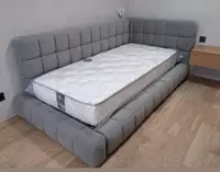 Burchakli karavot yumshoq orqa suyanish joylari bilan.