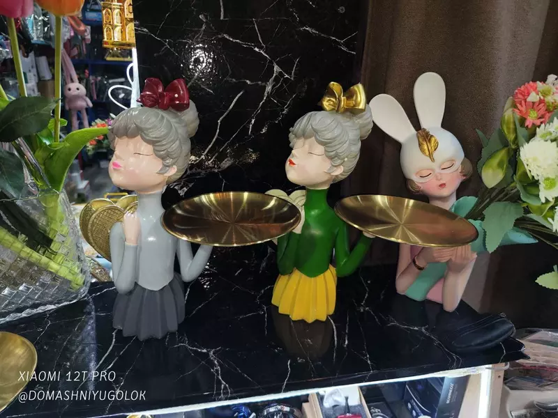 Статуэтка милой девочки с подносом и рюкзаком за спиной для хранения.