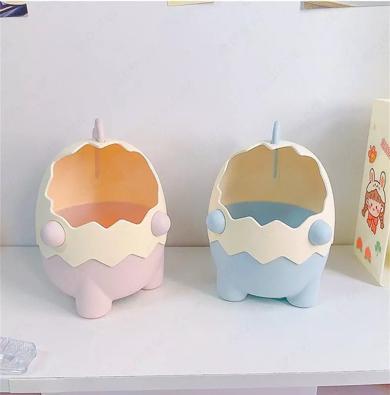 Органайзер в виде мультяшного динозавра в яичной скорлупе.