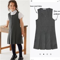 Doimiy burmalari bo'lgan qizlar uchun kulrang maktab sarafan